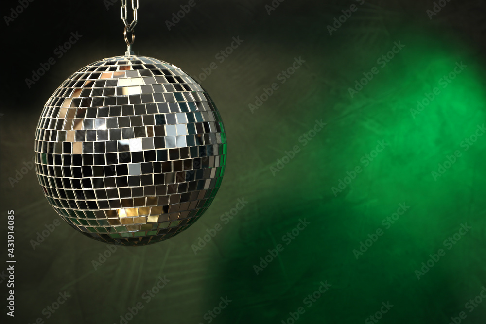 Fototapeta premium Shiny disco ball on dark background. Space for text