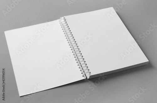 Open blank notebook on grey background. Mockup for design