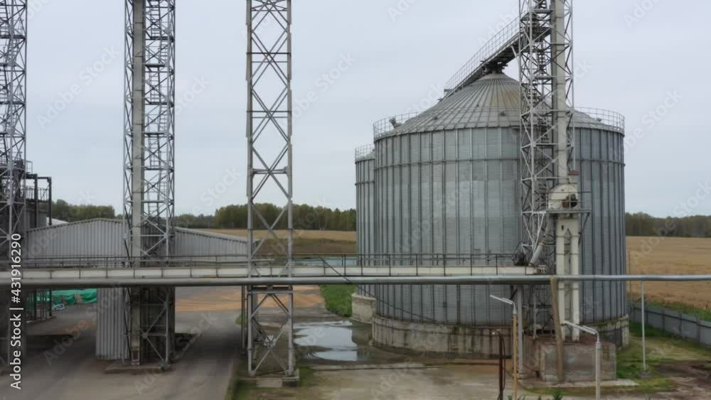 Grain processing plant working in the fields, the footage was shot on a quadrocopter in the autumn on a cloudy day Grain processing plant working in the fields, the footage was shot on a quadrocopter in the autumn on a cloudy day