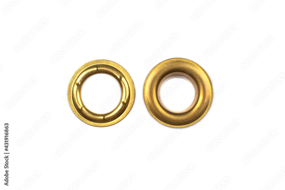 Catalogue photo of brass multicoloured metal eyelets or rivets - curtains rings for fastening fabric to the cornice, isolated on white background with copyspace for text. Selective focus Catalogue photo of brass multicoloured metal eyelets or rivets - curtains rings for fastening fabric to the cornice, isolated on white background with copyspace for text. Selective focus