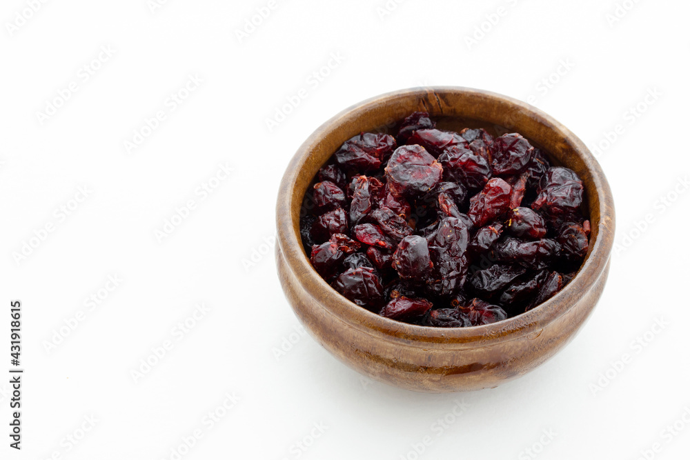 Dried blueberries in wooden bowl. Dry fruits. Dried blueberries in wooden bowl. Dry fruits.