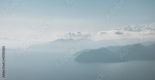View of the Greek island of Rhodes in the Aegean Sea from the top of the mountains on the Turkish side of the city of Dalyan. .islands in the sea in a blue haze