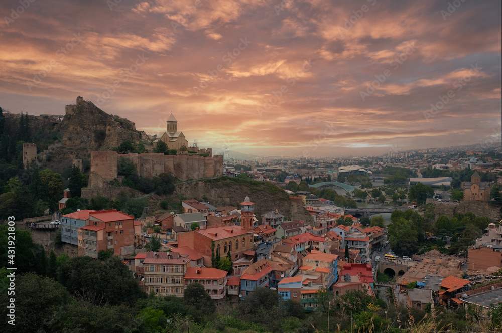 panoramic view of Tbilisi city and Narikala fortress at sunset late in the evening