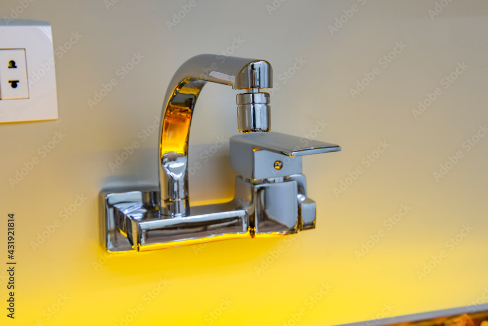 Modern kitchen design closeup of wall tap faucet Modern kitchen design closeup of wall tap faucet