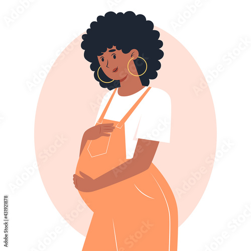 Young pregnant woman in overalls hugging belly with hands, pregnancy and motherhood
