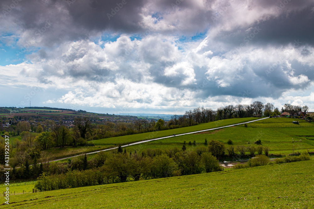 A dramatic sky during spring over the dutch rolling hills in the south of Limburg close to Maastricht.