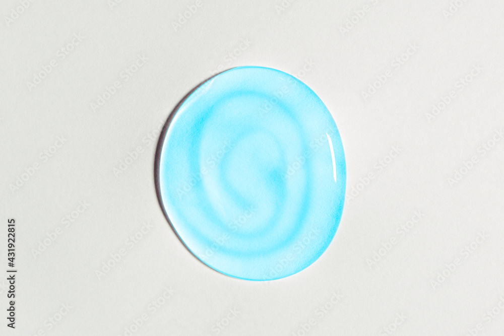 Blue transparent gel drop isolated on white background. Top view. Virus protection or cosmetics concept. Serum texture close up Blue transparent gel drop isolated on white background. Top view. Virus protection or cosmetics concept. Serum texture close up