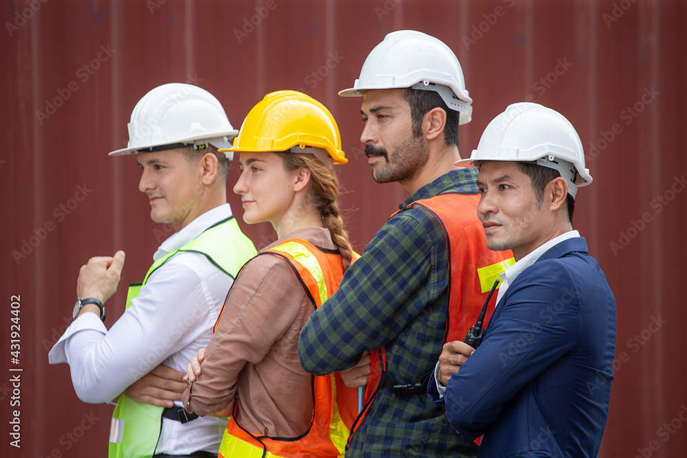 portrait group of container worker confident and smiling standing at warehouse logistic in Cargo freight ship for import export in harbor. shipping in docks . teamwork diversity employee arms crossed portrait group of container worker confident and smiling standing at warehouse logistic in Cargo freight ship for import export in harbor. shipping in docks . teamwork diversity employee arms crossed