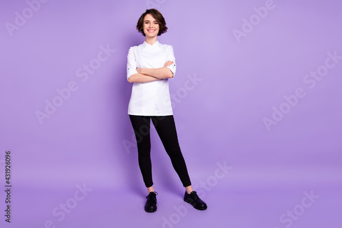 Full length photo of attractive young woman hold hands folded cook caterer isolated on violet color background