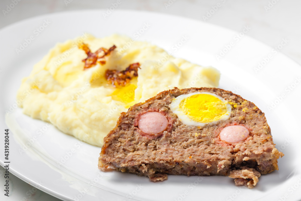 meat loaf filled with egg and sausage served with mashed potatoes and fried onion meat loaf filled with egg and sausage served with mashed potatoes and fried onion