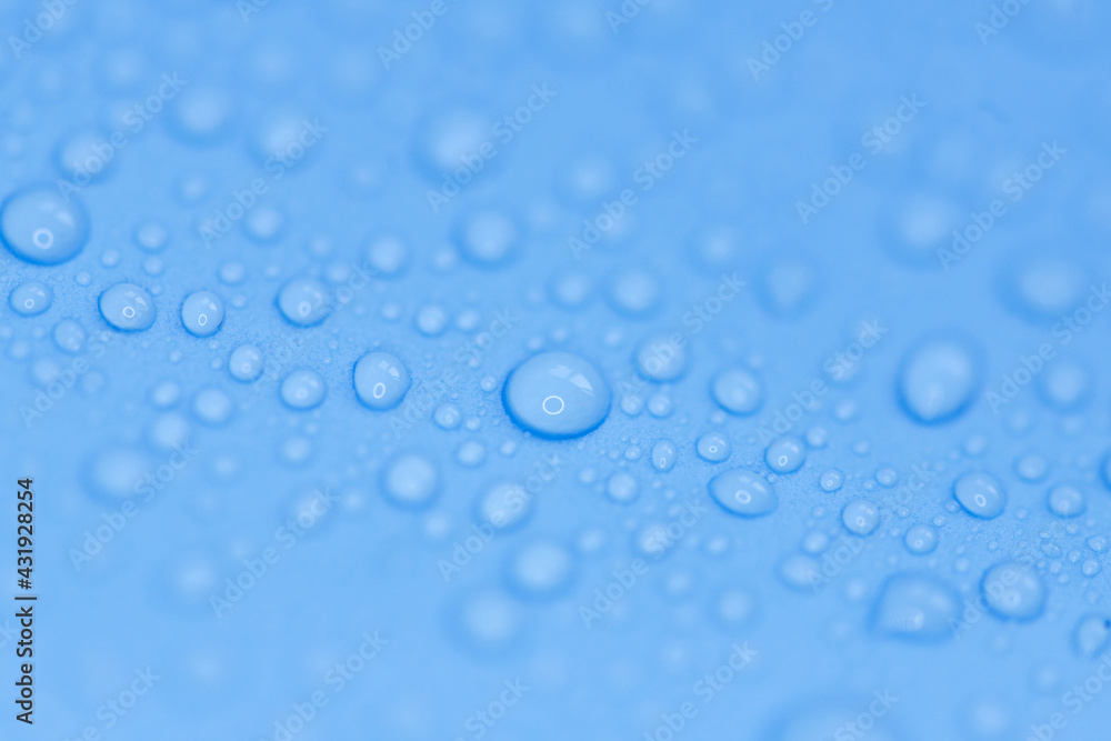 Random water drops on the blue PVC surface