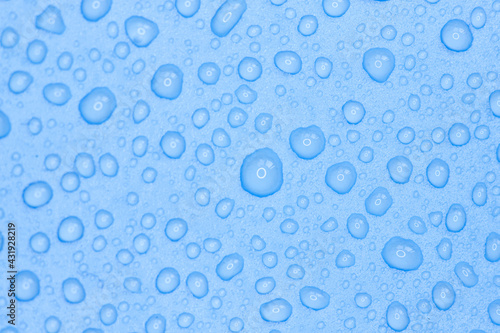 Random water drops on the blue PVC surface