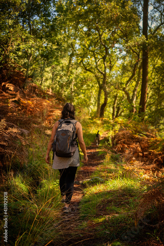 Caucasian woman hiking on a trail in nature landscape fall landscape in Mondim de Basto, Portugal © Luis