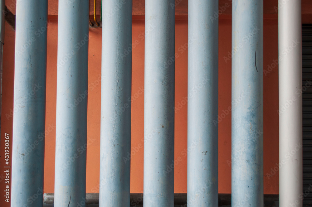 Vertical pvc pipe on orange background Vertical pvc pipe on orange background