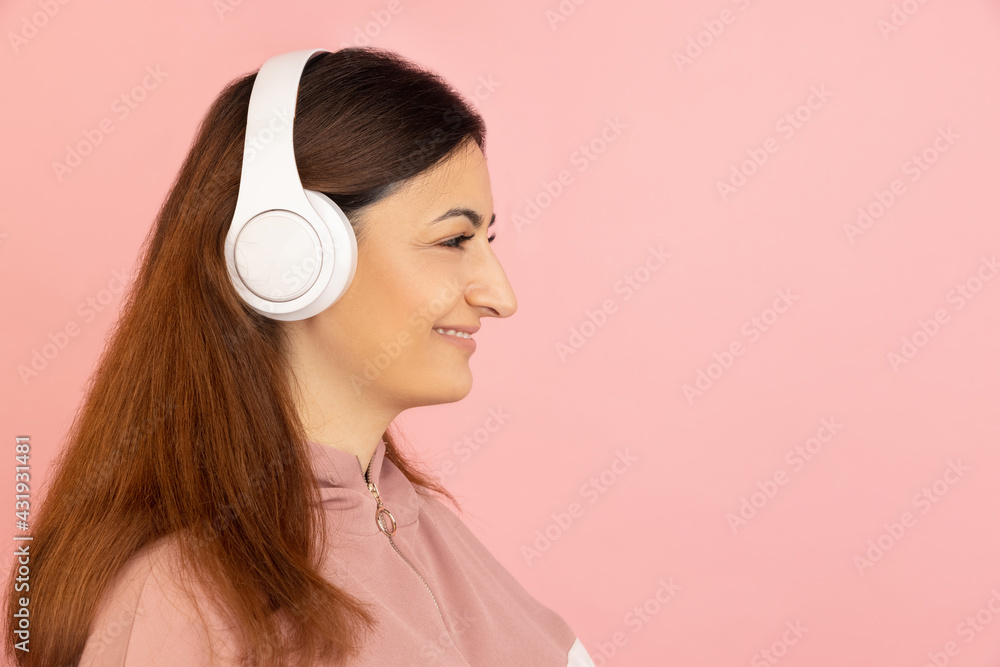 Young woman's portrait on pink studio background. Concept of human emotions, facial expression, youth, sales, ad. Young woman's portrait on pink studio background. Concept of human emotions, facial expression, youth, sales, ad.