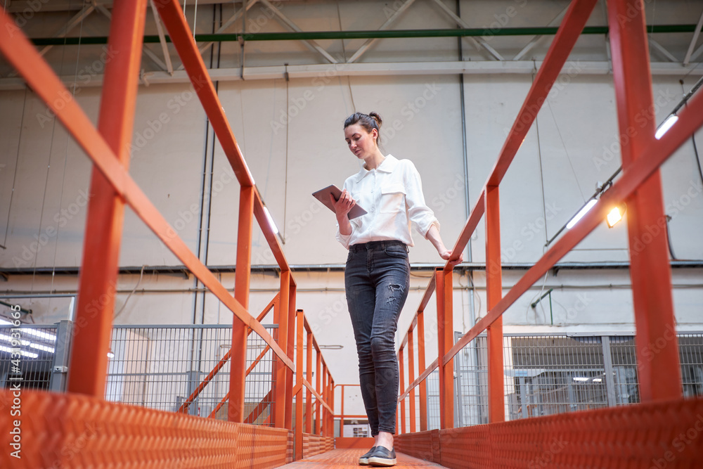 Business woman in Industrial Carpentry factory - production of wooden boards with modern machines