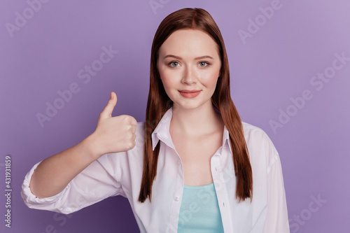 Beautiful young woman give thumb up isolated on violet background