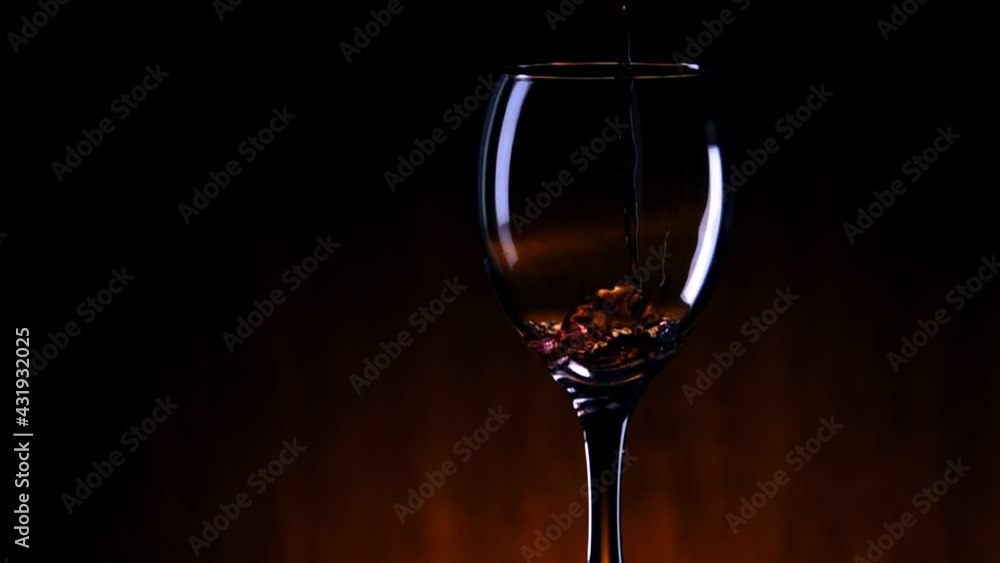 Pouring red wine from bottle. Close-up of red wine in glass close up Pouring red wine from bottle. Close-up of red wine in glass close up
