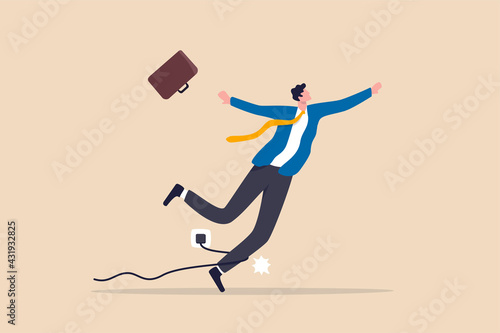 Failure or mistake, accident or surprise problem that impact business concept, clumsy businessman stumble with power cable electric plug falling on the floor.