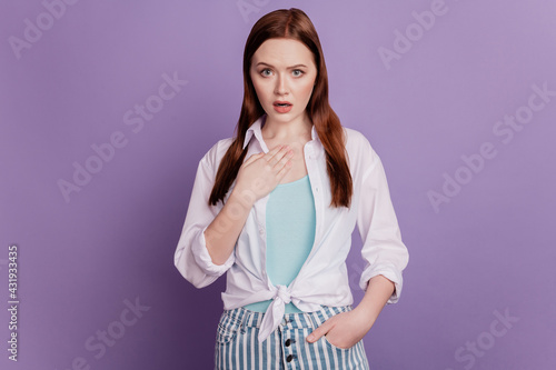 Portrait of offended surprised lady hand chest look camera on purple background