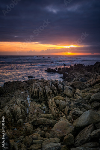 Beautiful sunset rock beach landscape peaceful relaxing with waves crashing atlantic ocean in Spain