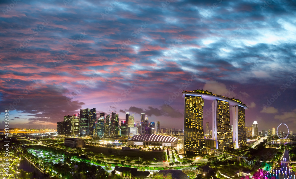 Fototapeta premium Sunset aerial view of Singapore from drone, view from Gardens By The Bay
