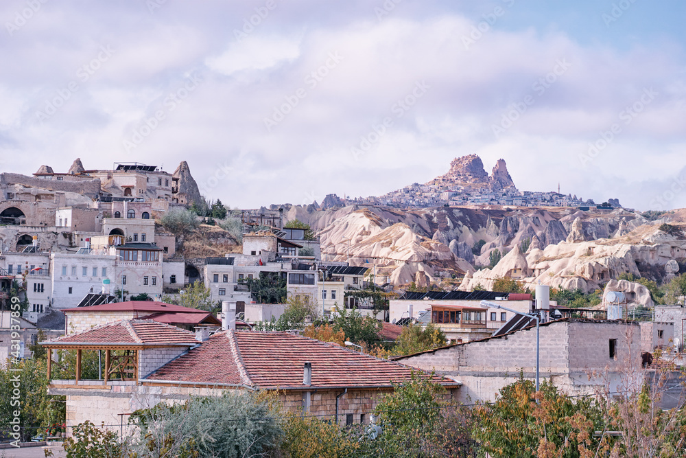 Traveling in Turkey. Beautiful landscape of Cappadocia town with caves, mountains and houses.