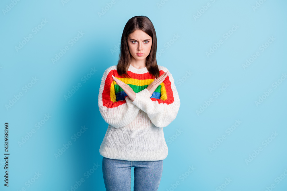 Photo of serious upset young lady wear striped outfit arms crossed showing stop isolated blue color background Photo of serious upset young lady wear striped outfit arms crossed showing stop isolated blue color background
