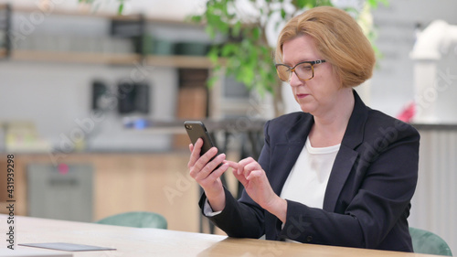 Serious Businesswoman using Smartphone in Office Free Download Serious Businesswoman using Smartphone in Office - GFXLoad