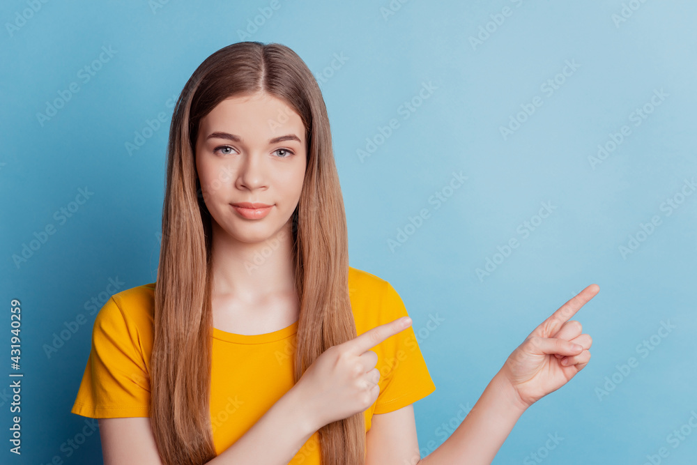 Portrait of promoter girl direct finger away empty space on blue background Portrait of promoter girl direct finger away empty space on blue background