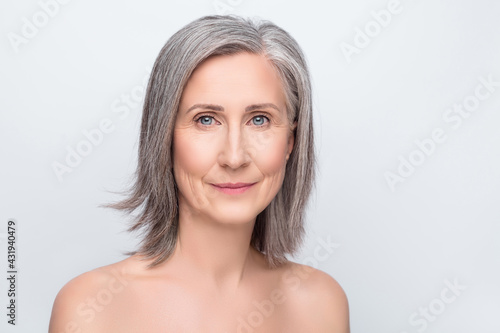 Photo of serious charming old woman flawless skin moisturizing face hydration isolated on grey color background