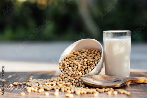 Delicious soy milk on wooden table background with Sunlight in the morning. Fresh healthy drink concept.