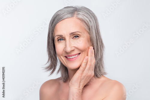 Portrait of attractive naked cheerful woman touching flawless skin hygiene detox isolated over gray pastel color background