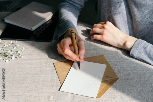 Bild auf Leinwand Woman writing romantic letter or wedding invitation card