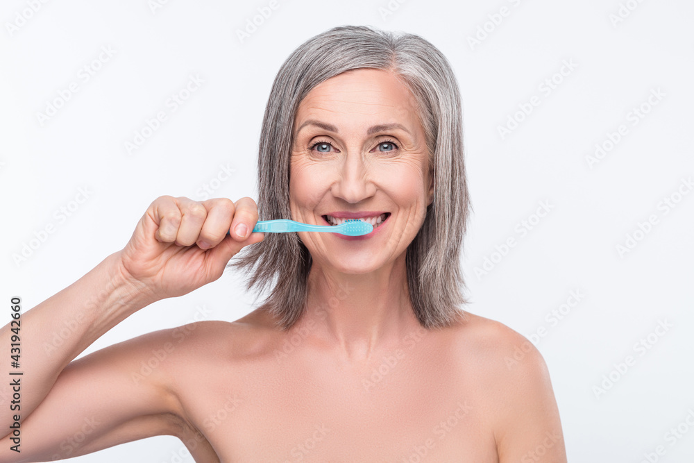 Portrait of attractive nude healthy woman brushing teeth fresh breath anti caries isolated over gray pastel color background Portrait of attractive nude healthy woman brushing teeth fresh breath anti caries isolated over gray pastel color background