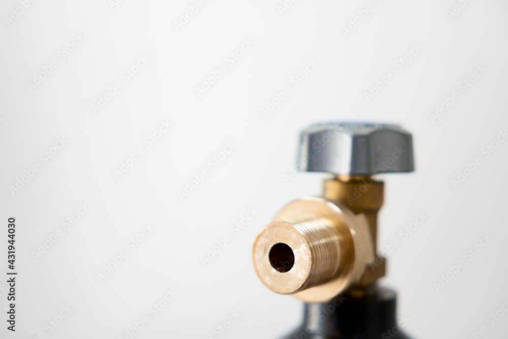 Brass connector and valve on the gas cylinder.