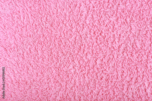 Pink fuzzy fabric close up. Fleece cozy towel background with space for text photo