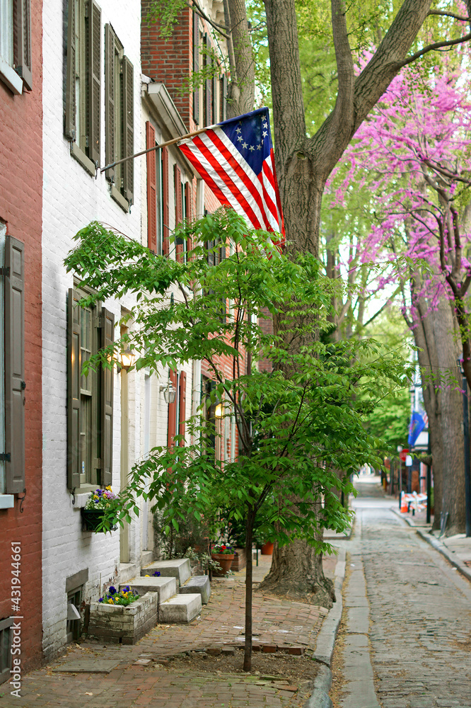 Cityscape with American flag in old area. Philadelphia, USA