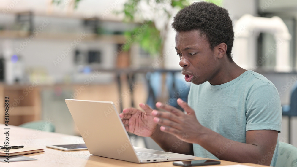 Loss, Young African Man reacting to Failure on Laptop Loss, Young African Man reacting to Failure on Laptop