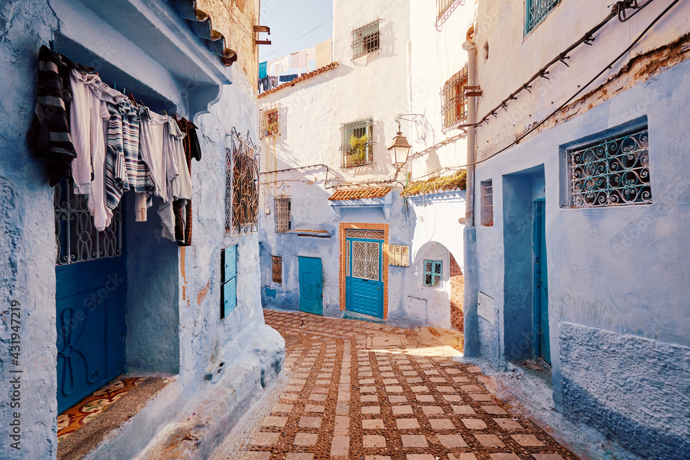 Public pedestrian street in old town Medina of Chefchaouen, Morocco. Chefchaouen or Chaouen is known that the houses in this city are painted in blue.