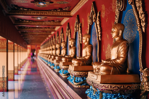 Many Golden statues of Buddha in thai temple.