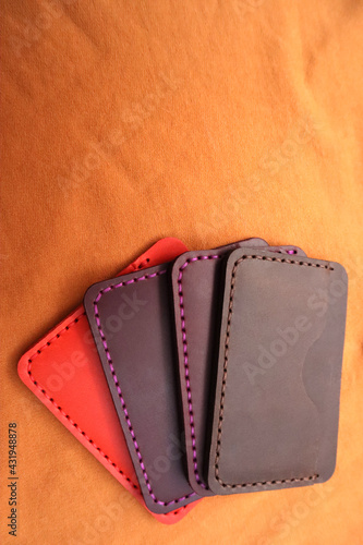 Handmade leather cardholders on a brown background