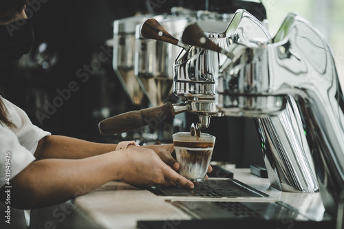 Close-Up of professional coffee machine making a cup of coffee. It's coffeemakers or coffee machines are cooking appliances used to coffee