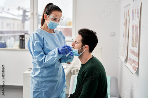 Female doctor taking sample for coronavirus testing, Poland, podkarpackie, Dƒôbica