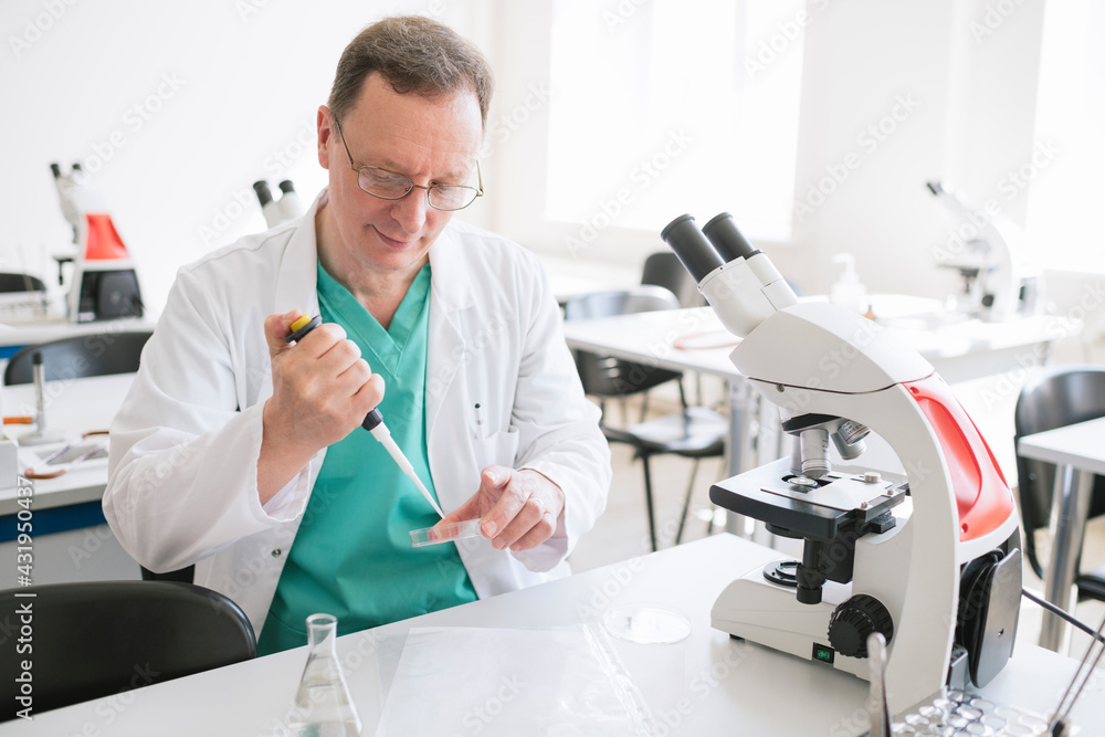 Researcher in white coat working in lab Researcher in white coat working in lab