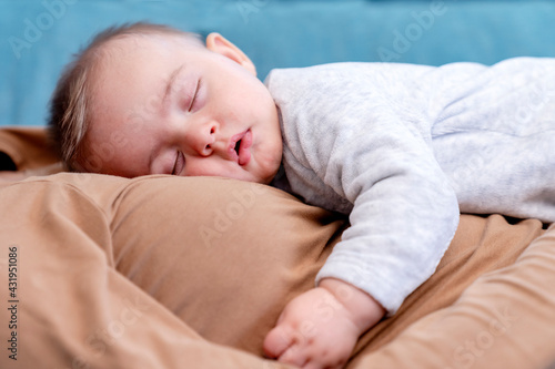 Baby boy sleeping on mother at home photo