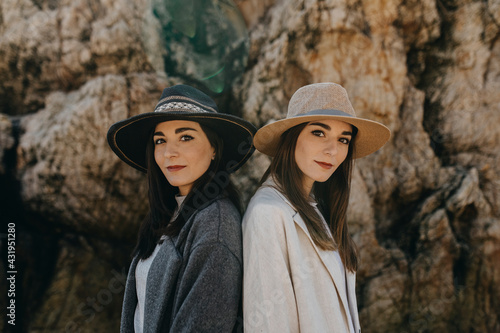 Young female twins by rock formation photo