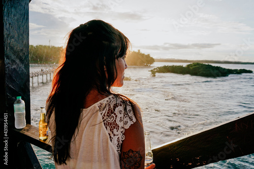 Woman watching the sunset on Siargao Island, Philippines photo