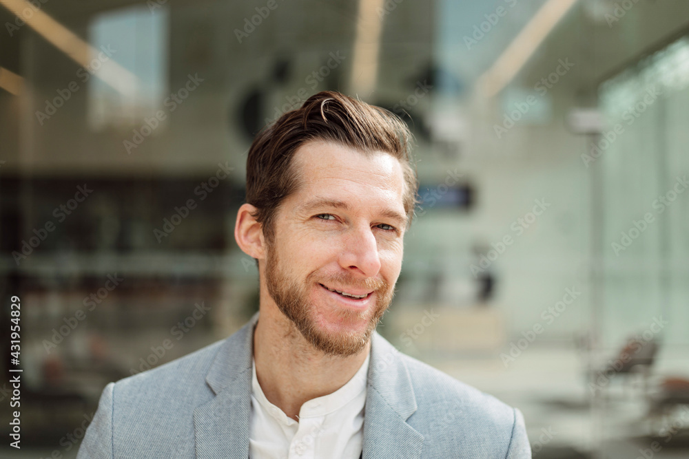 Smiling handsome male professional with brown hair and beard Smiling handsome male professional with brown hair and beard