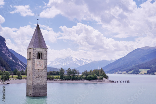 Beautiful view of the lake Resia. Famous tower in the water. Alps  Italy  Europe.
